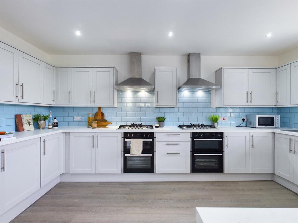 A modern and spacious kitchen featuring sleek c...