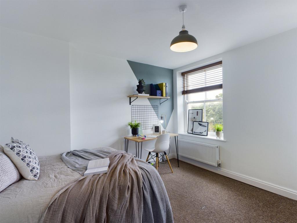 A bright and inviting double bedroom featuring ...