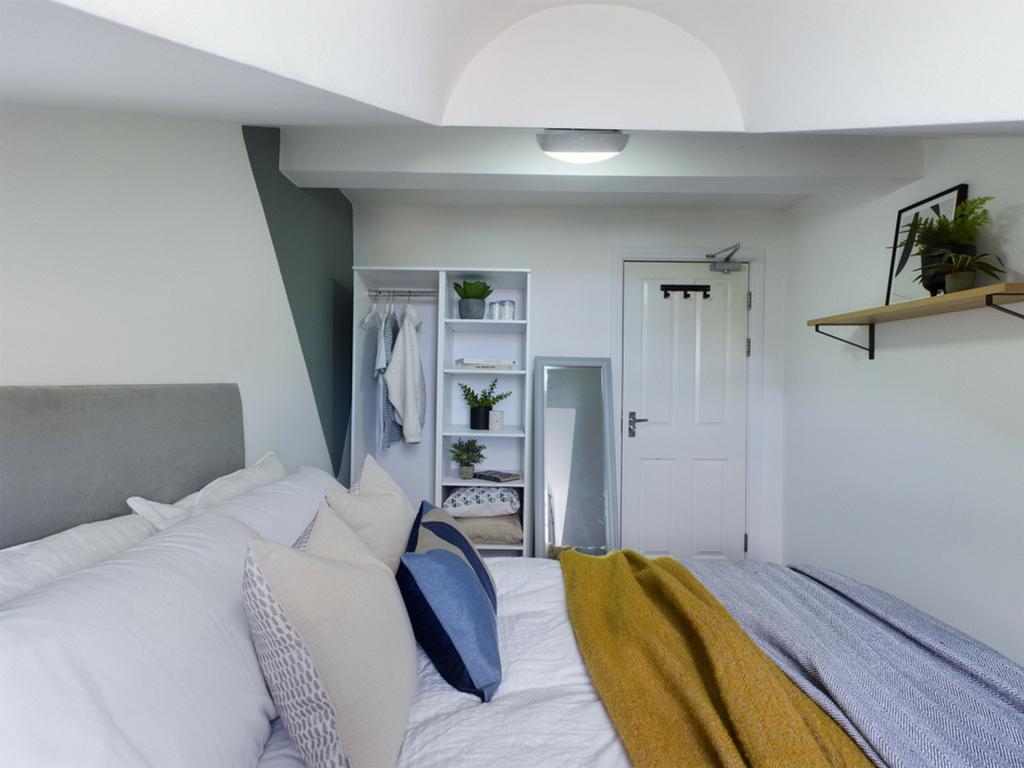 A bright and inviting double bedroom with moder...