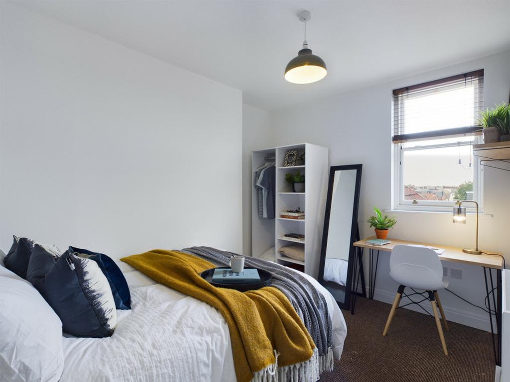 A spacious and bright double bedroom featuring ...