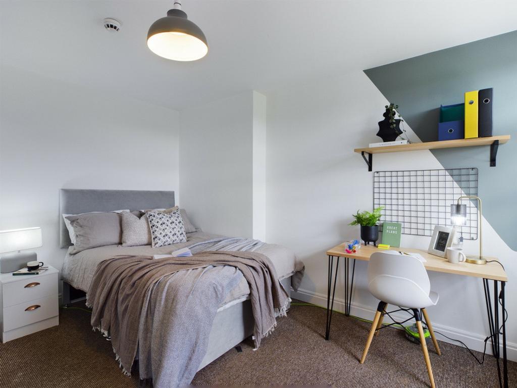 A bright and inviting double bedroom featuring ...