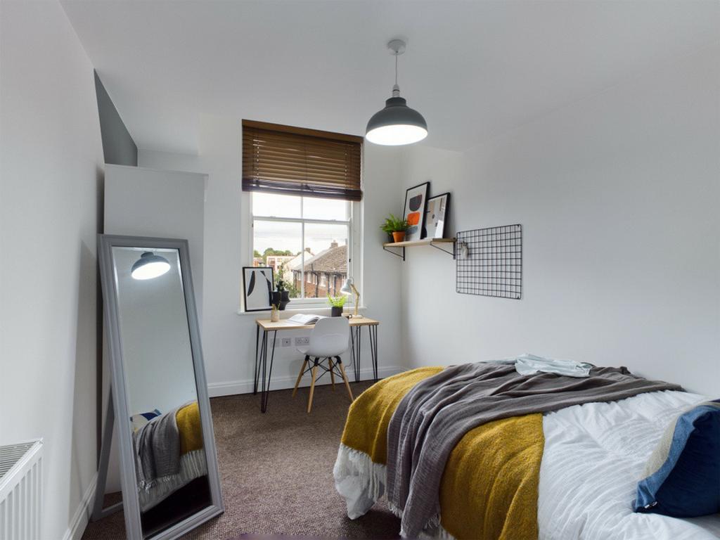 A bright and inviting double bedroom featuring ...