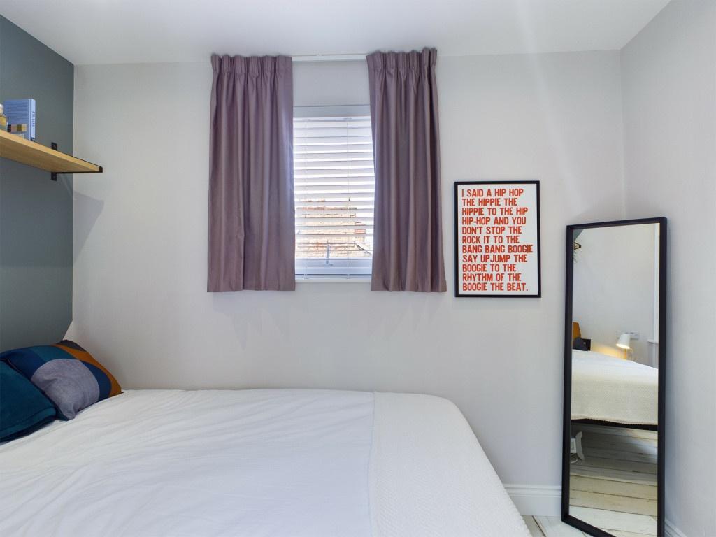 A neatly presented bedroom featuring a large be...