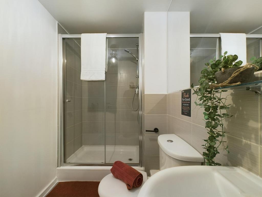 A clean, modern bathroom featuring a spacious s...