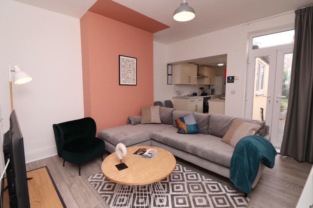 A spacious and modern living room featuring com...