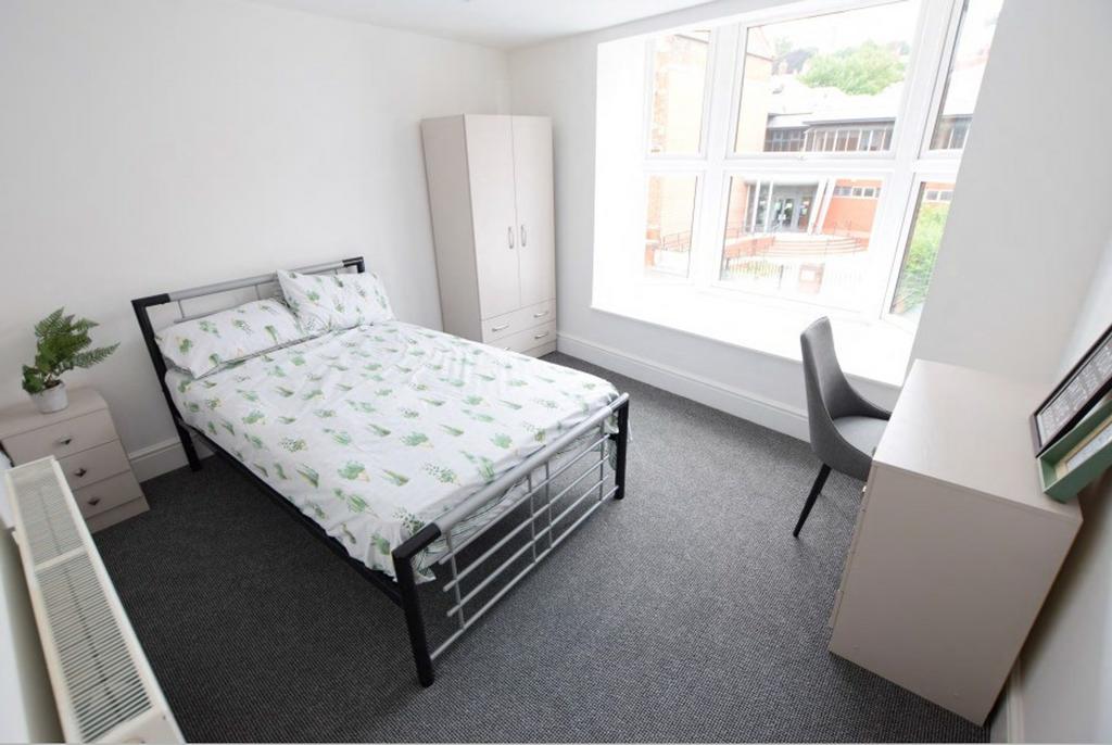A bright and spacious double bedroom featuring ...