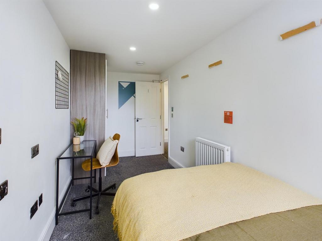 A bright and spacious double bedroom featuring ...