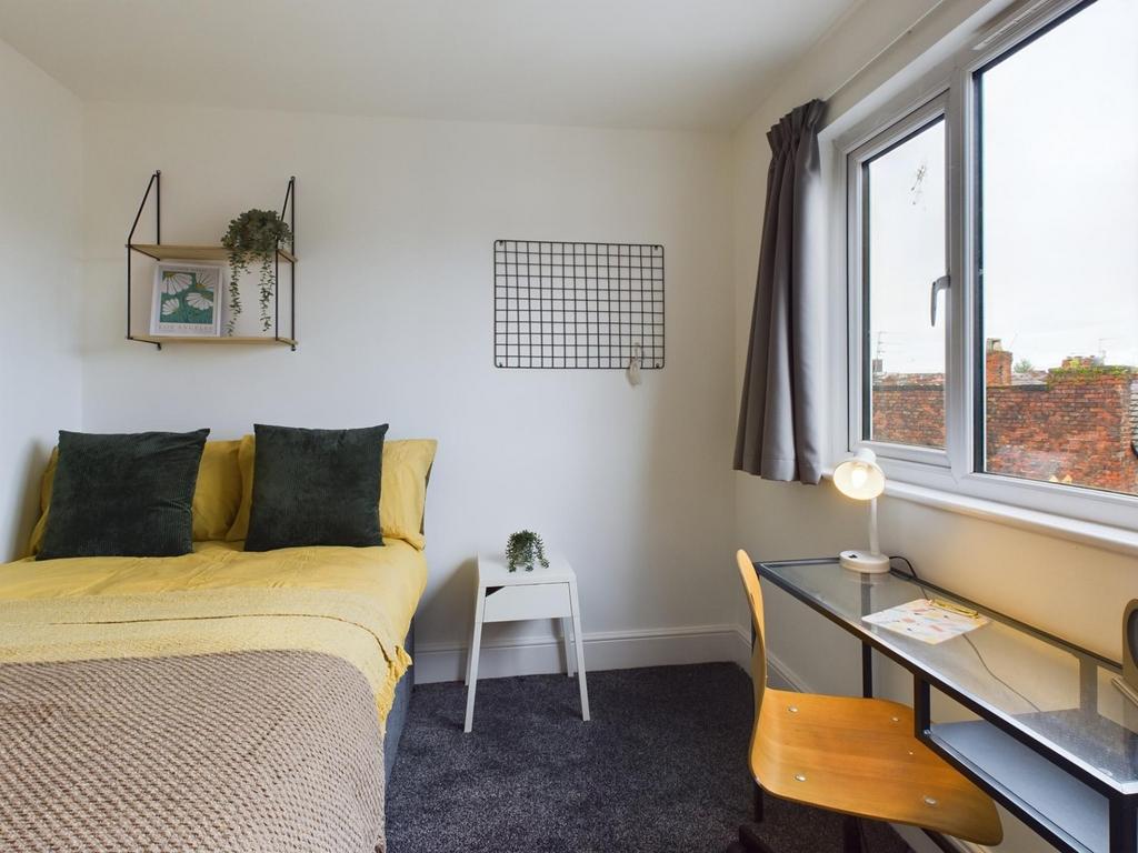 A bright and inviting double bedroom with moder...