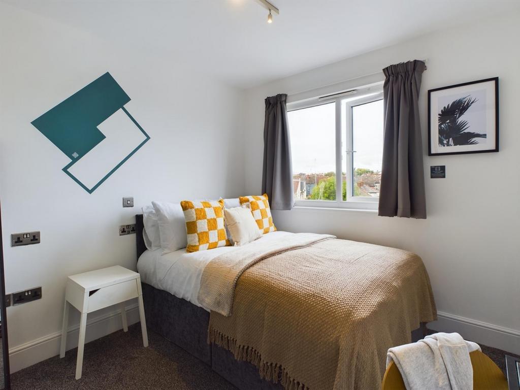 A bright and inviting double bedroom featuring ...