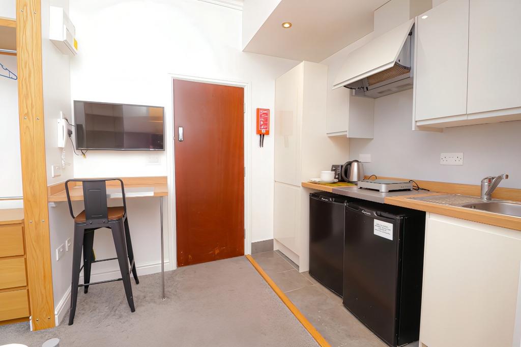 A modern kitchenette with ample space and good ...
