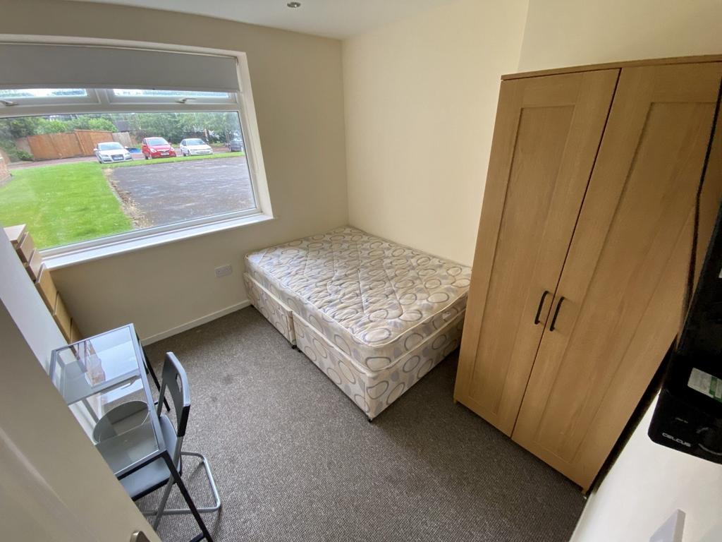 A bright and tidy double bedroom with a comfort...