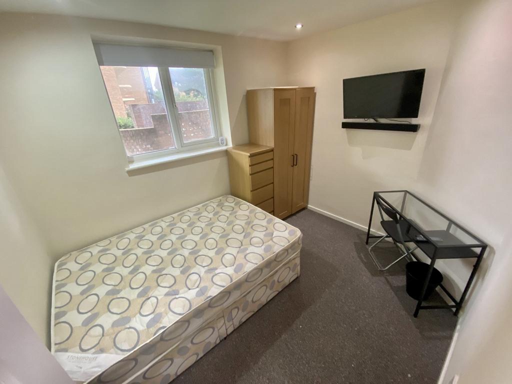 A cozy double bedroom featuring ample storage a...