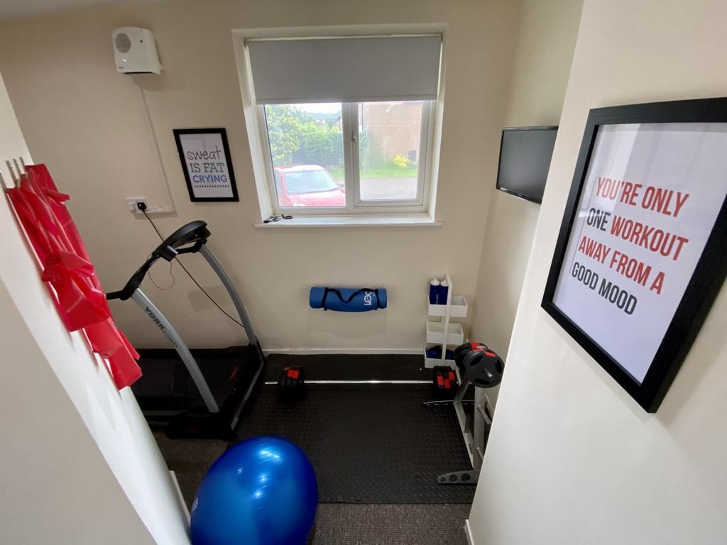 A bright and tidy gym space equipped for workou...