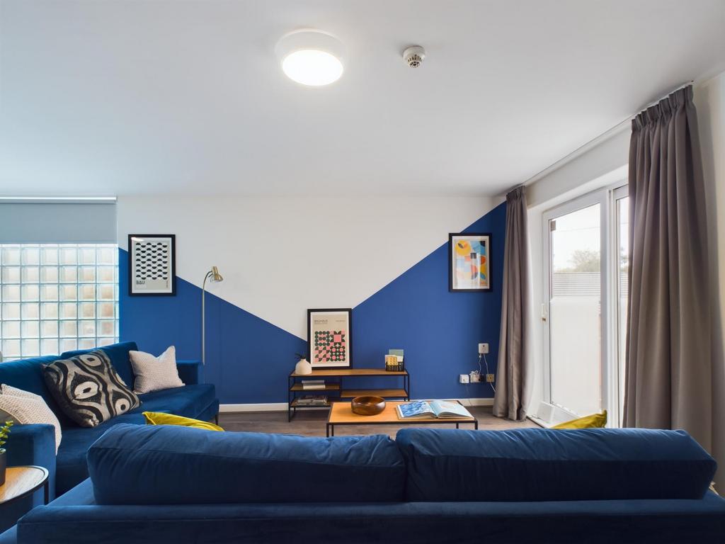 A spacious and modern living room featuring a v...