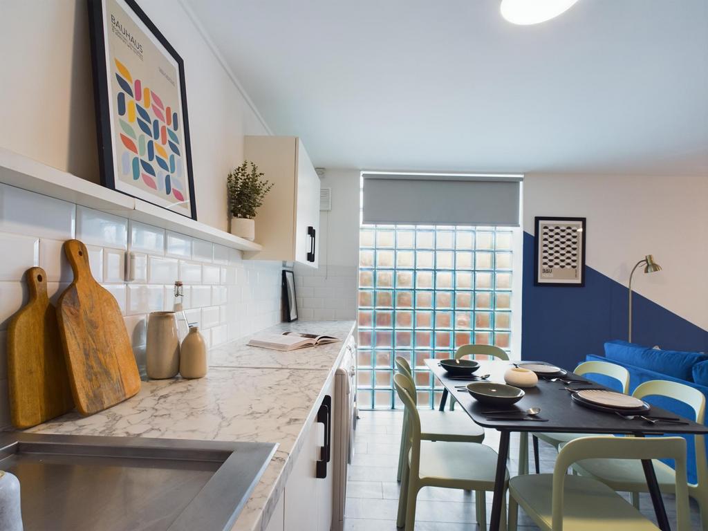 A modern and well-lit kitchen featuring a marbl...