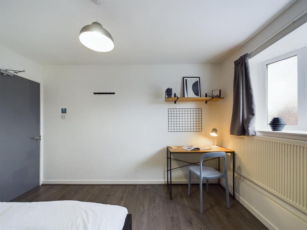 A bright and cozy bedroom featuring natural lig...