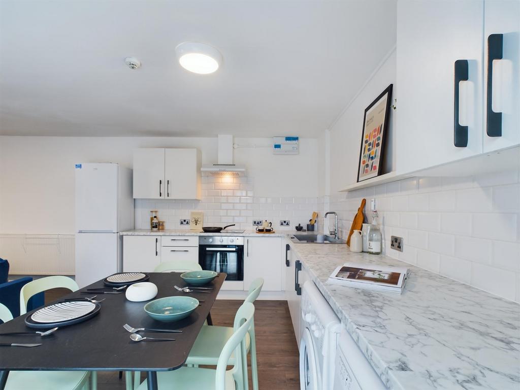 Bright and modern kitchen with ample storage, w...