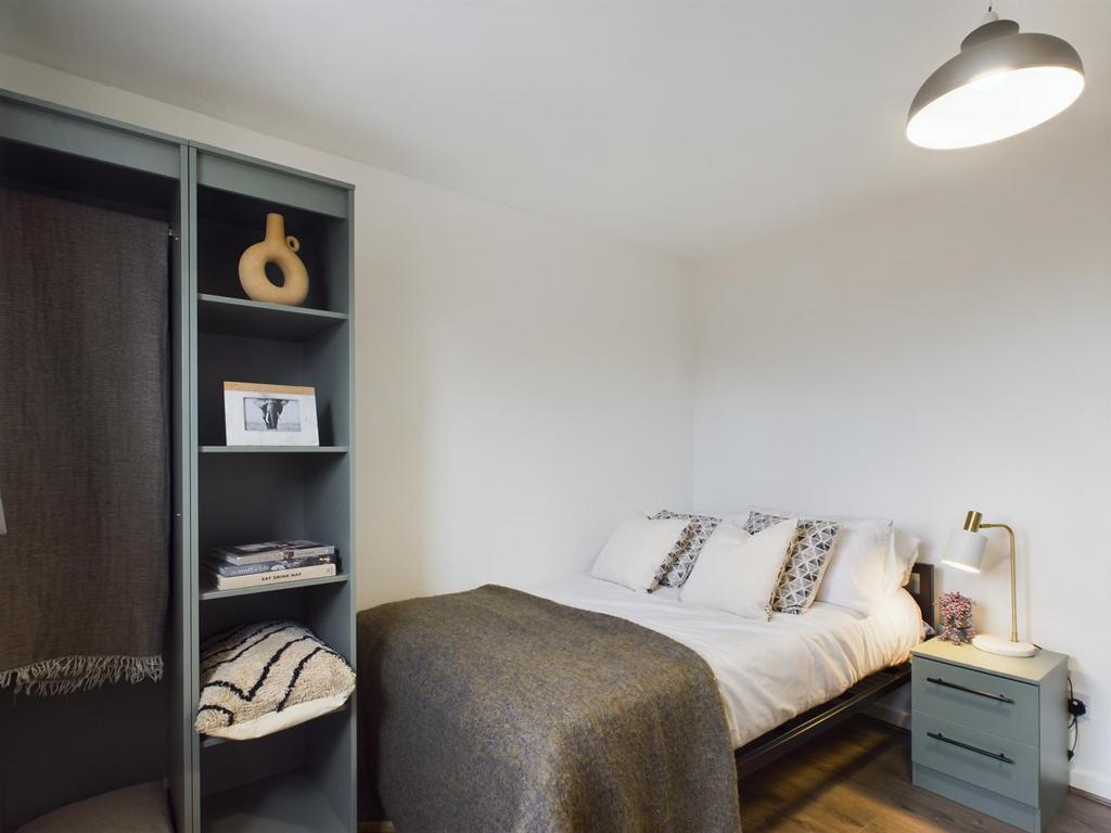 A cozy and well-maintained bedroom featuring a ...