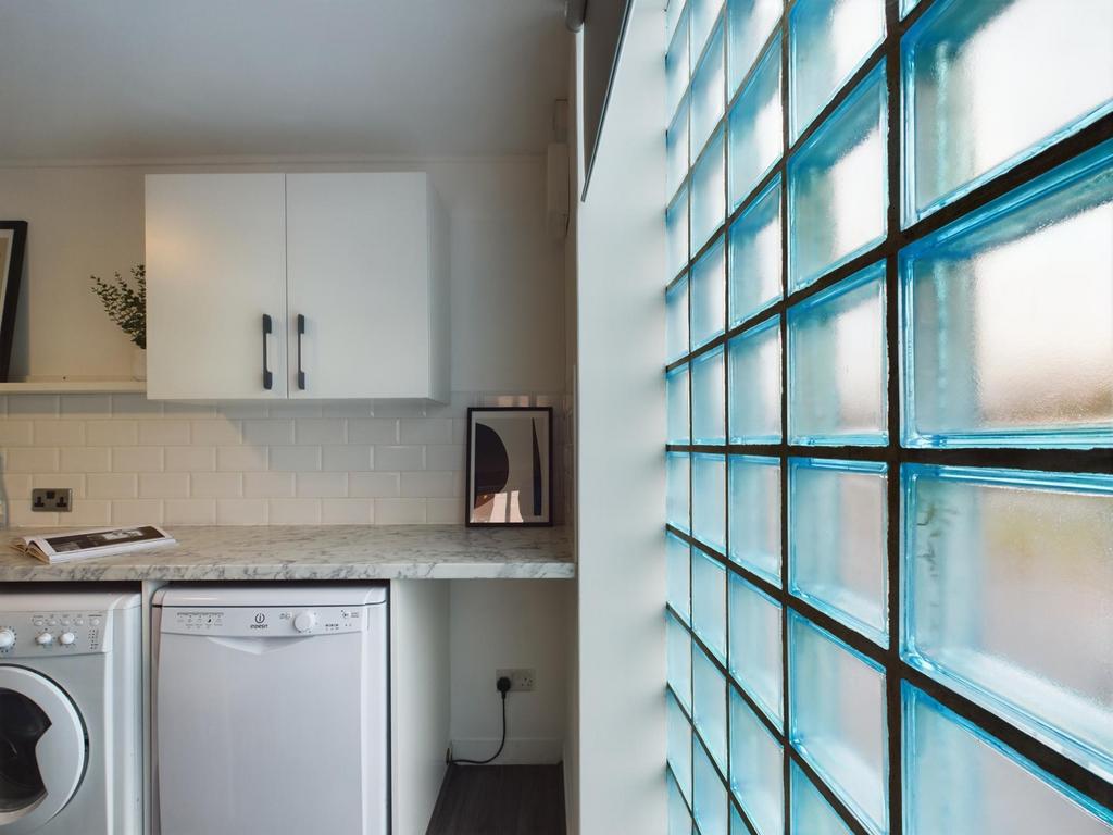 A bright and modern kitchen with ample natural ...