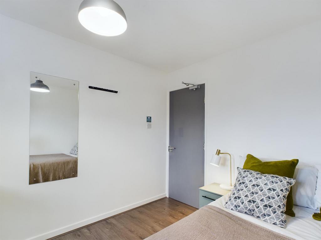 A bright and tidy master bedroom featuring a co...