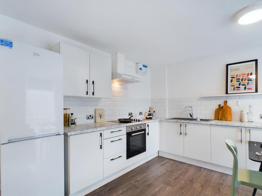 Bright and modern kitchen with ample white cabi...