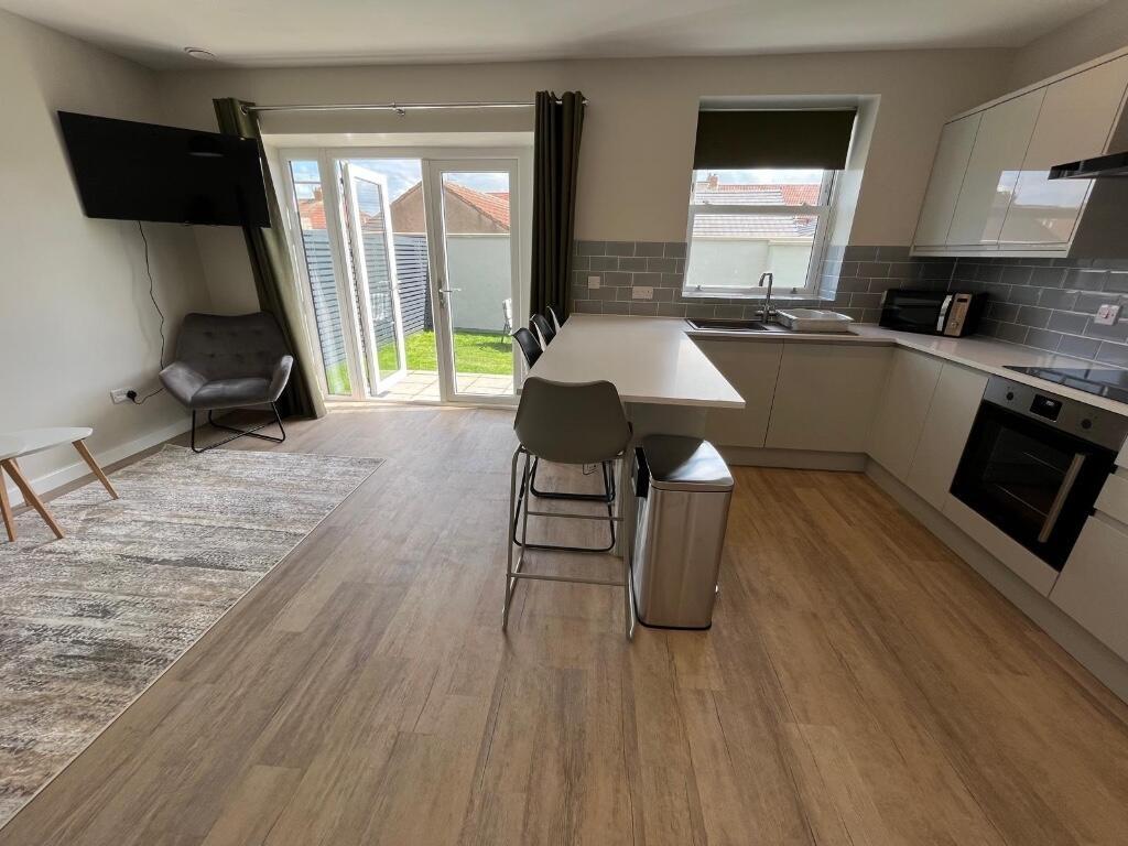 Bright and spacious living area featuring large...
