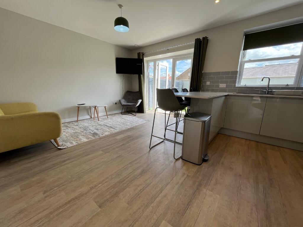 A spacious, well-lit living room with contempor...