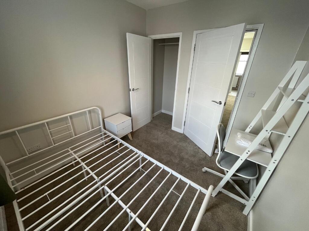 A well-maintained bedroom featuring a metal bed...