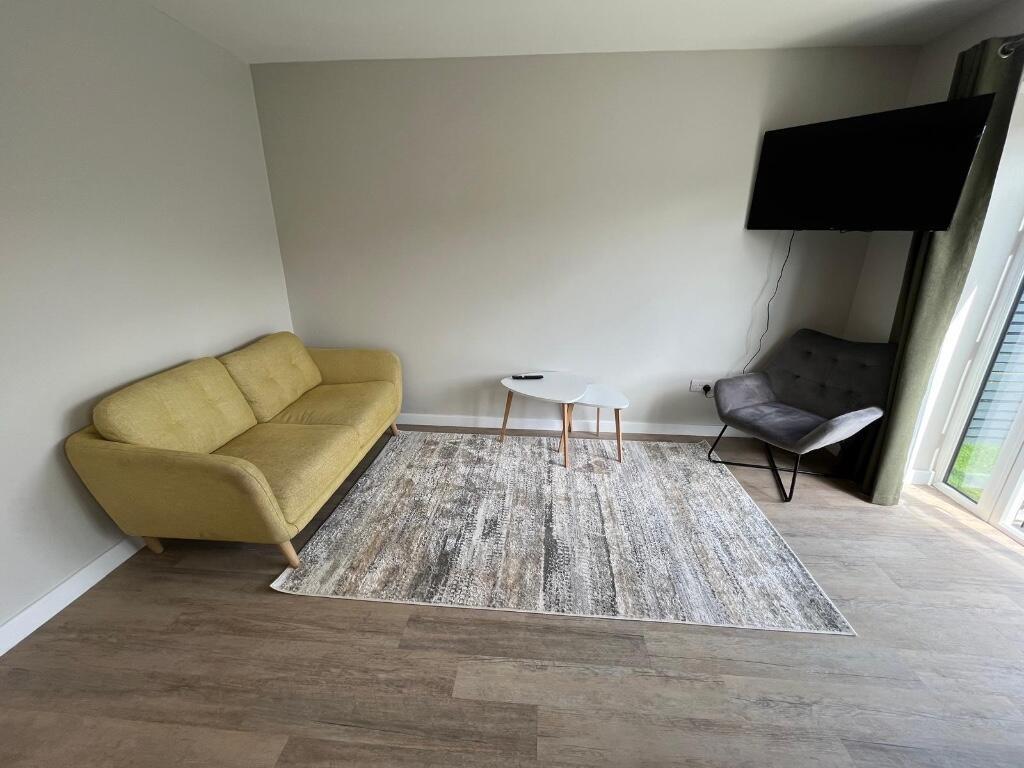 A bright and modern living room featuring a yel...