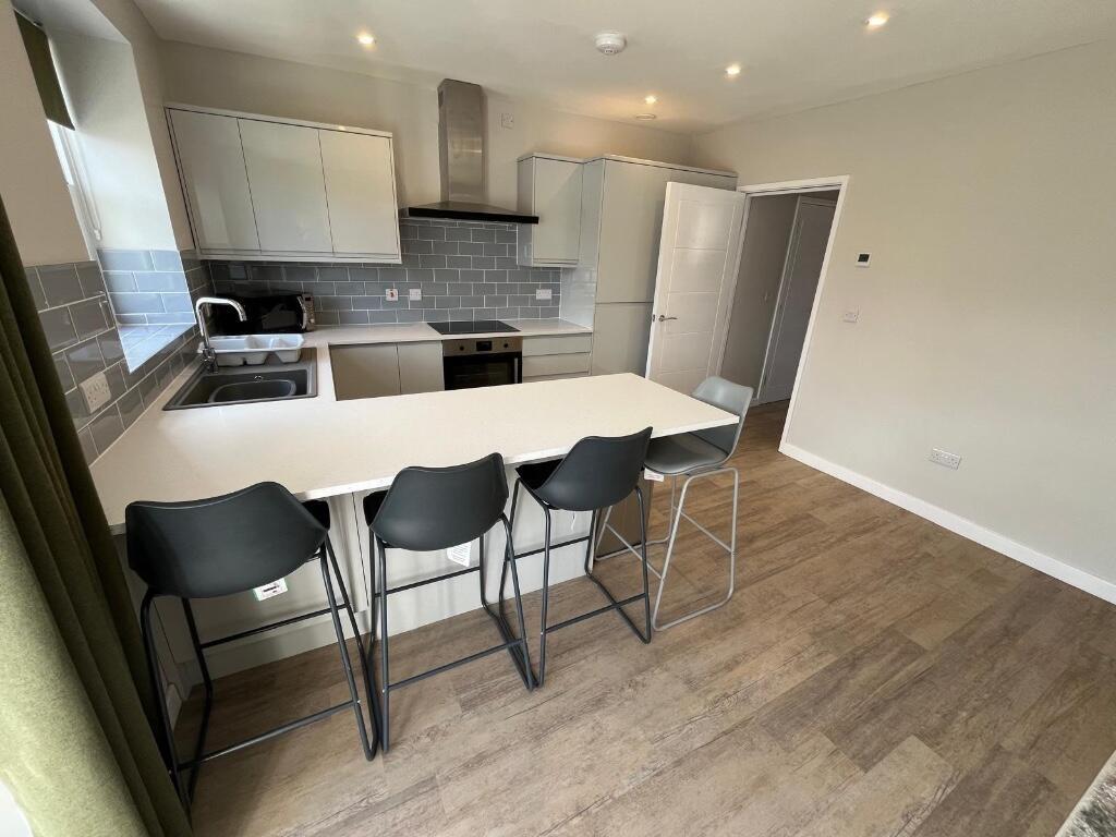 Modern kitchen area featuring a clean layout wi...