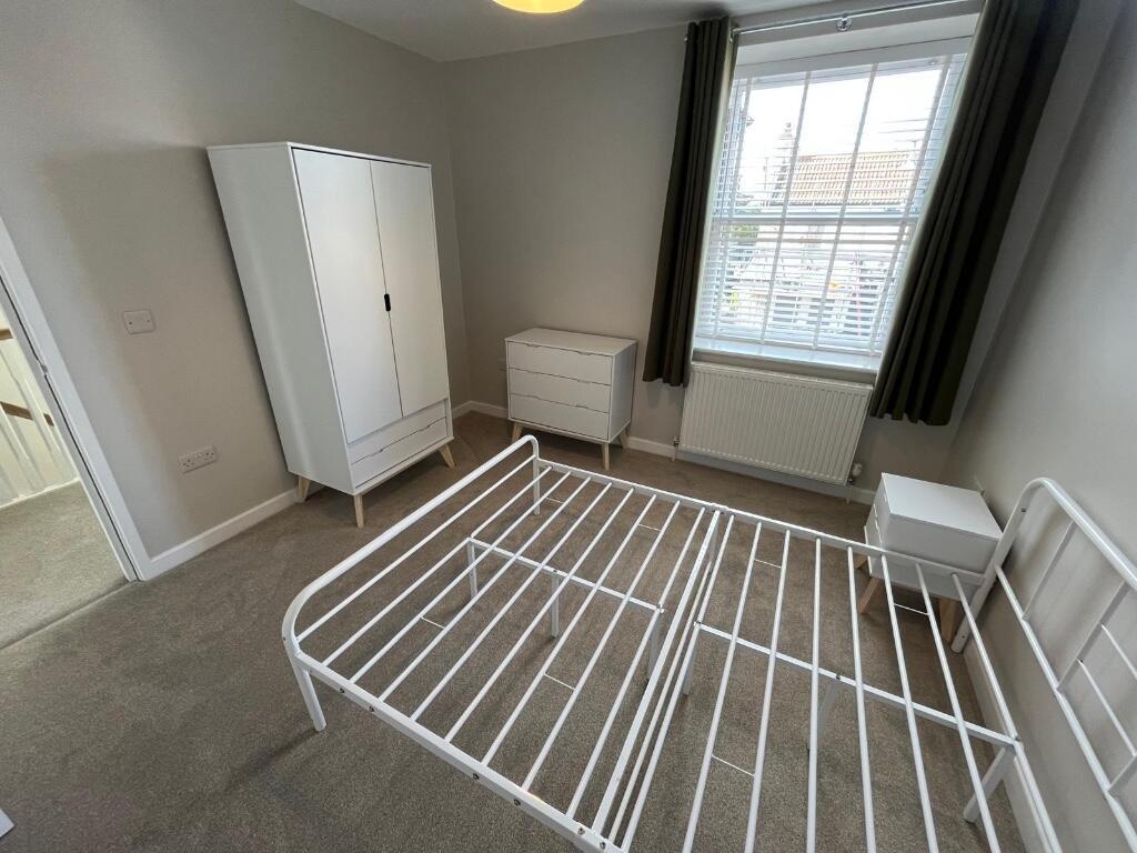 A simple, clean bathroom with a white toilet an...