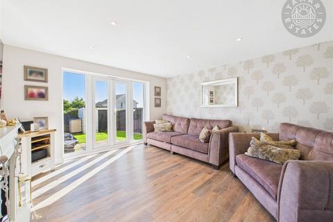 undefined, “An attractive and well-designed townhouse, perfect for families, with four bedrooms and two allocated parking spaces.”