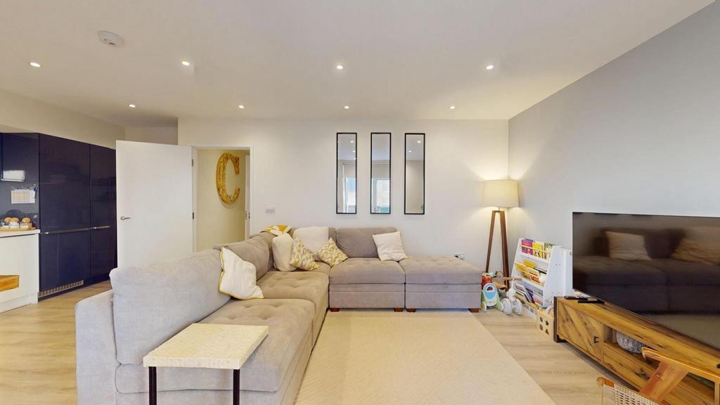 A spacious and modern living room featuring a l...