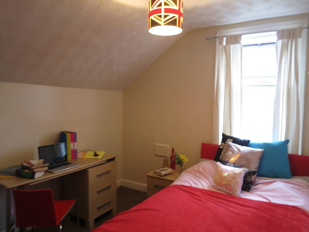 A spacious and well-lit master bedroom with a c...