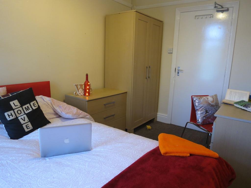 A comfortable bedroom featuring a double bed wi...