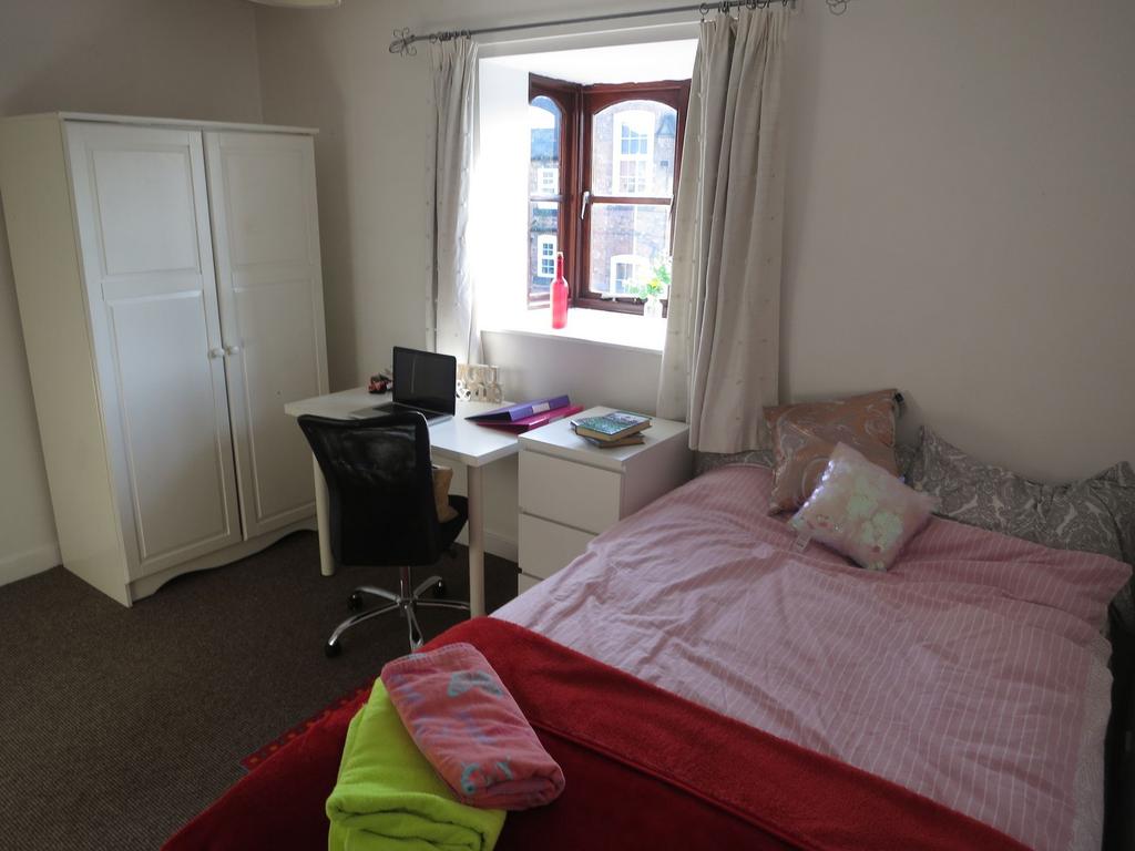 A cozy and well-maintained bedroom featuring a ...