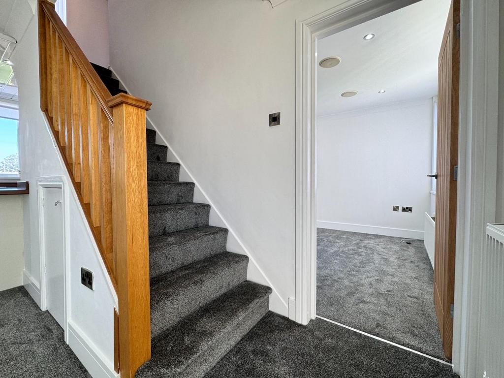 Stairs to the first floor and access into the loun