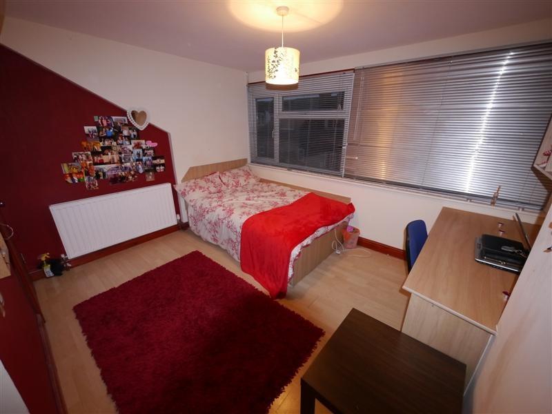 Cozy single bedroom featuring a comfortable bed...