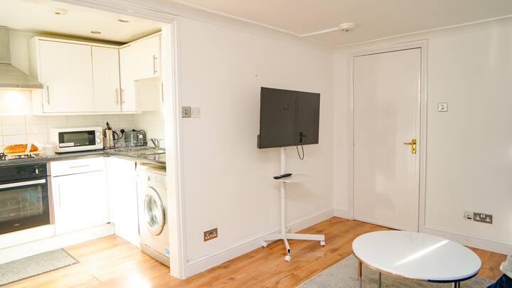 Bright and modern kitchen area with white cabin...