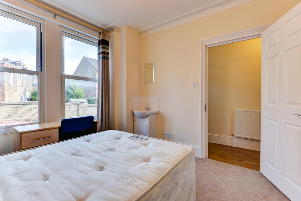 A bright and welcoming double bedroom featuring...