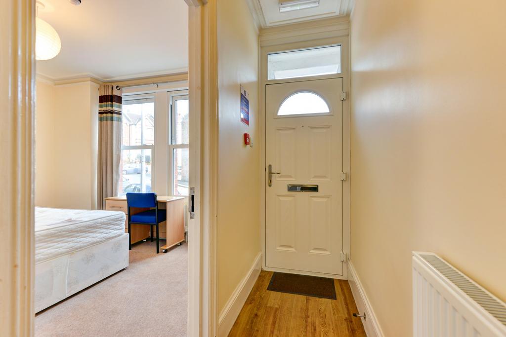 A bright and welcoming hallway with a white fro...