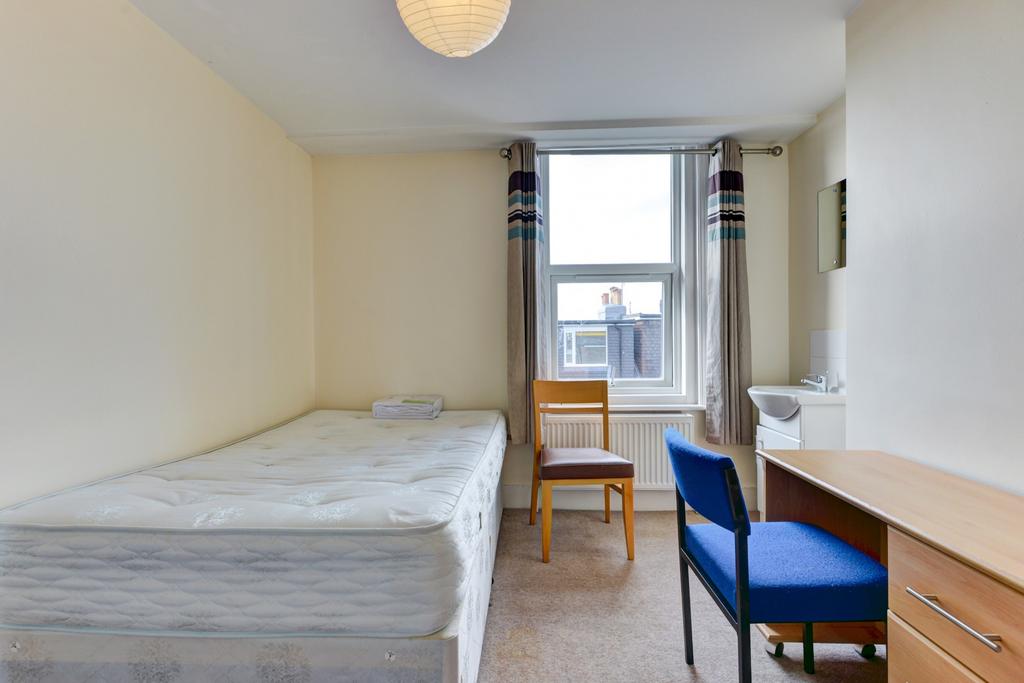 Bright and cozy single bedroom featuring a larg...