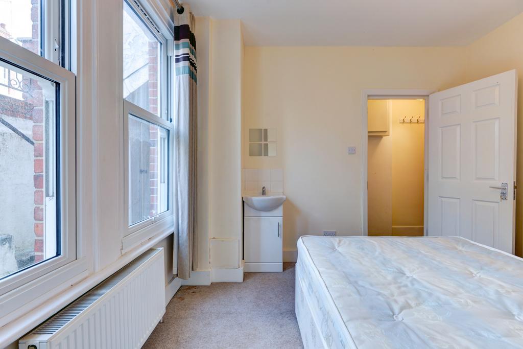 A bright and tidy double bedroom featuring larg...