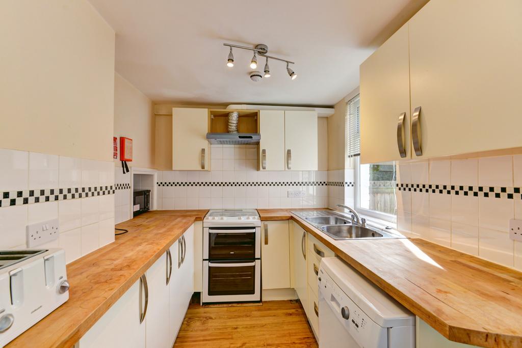 Bright and tidy kitchen featuring ample wooden ...