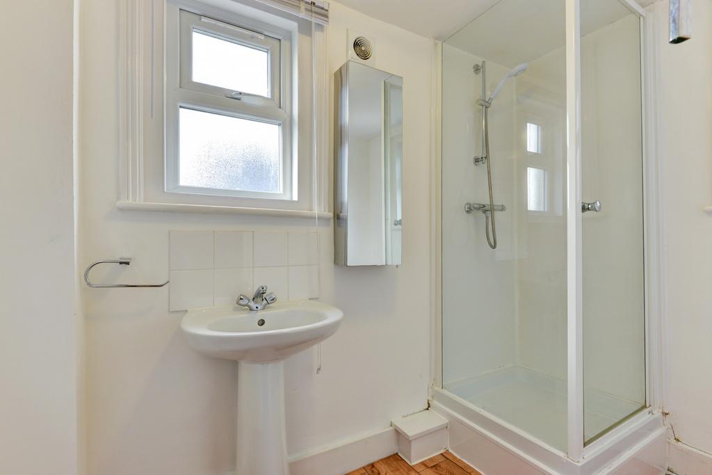 Bright and clean bathroom featuring a modern sh...