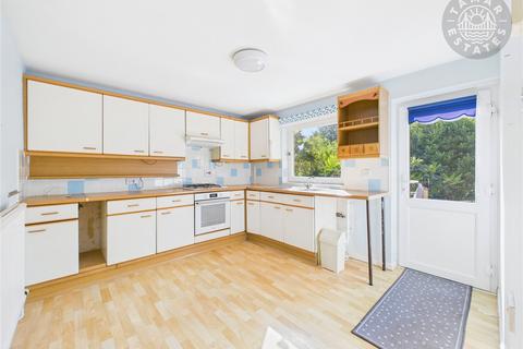 undefined, “Spacious end-terrace in a sought-after coastal town.”
