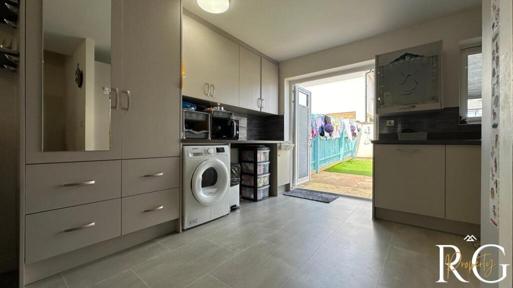 A bright and clean kitchen area featuring moder...