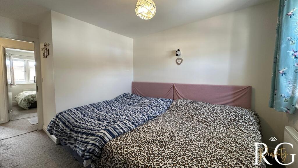 A comfortable double bedroom featuring a large ...