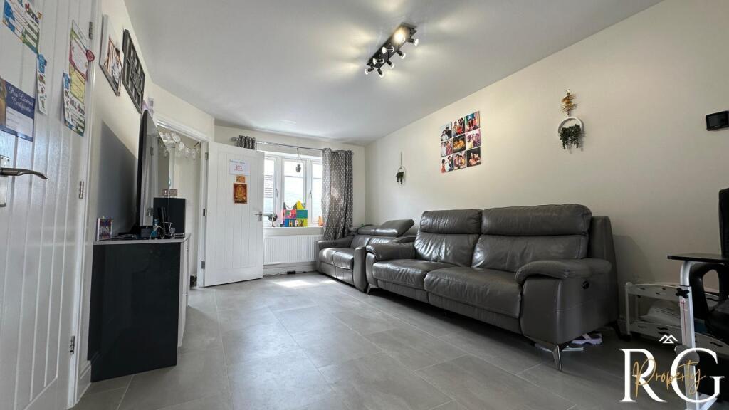 A contemporary living room featuring a large, c...