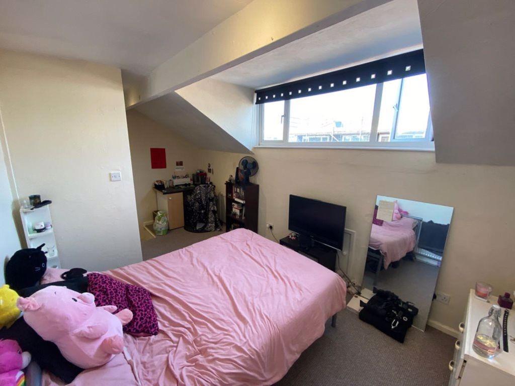 A bright and cozy bedroom with a comfortable do...